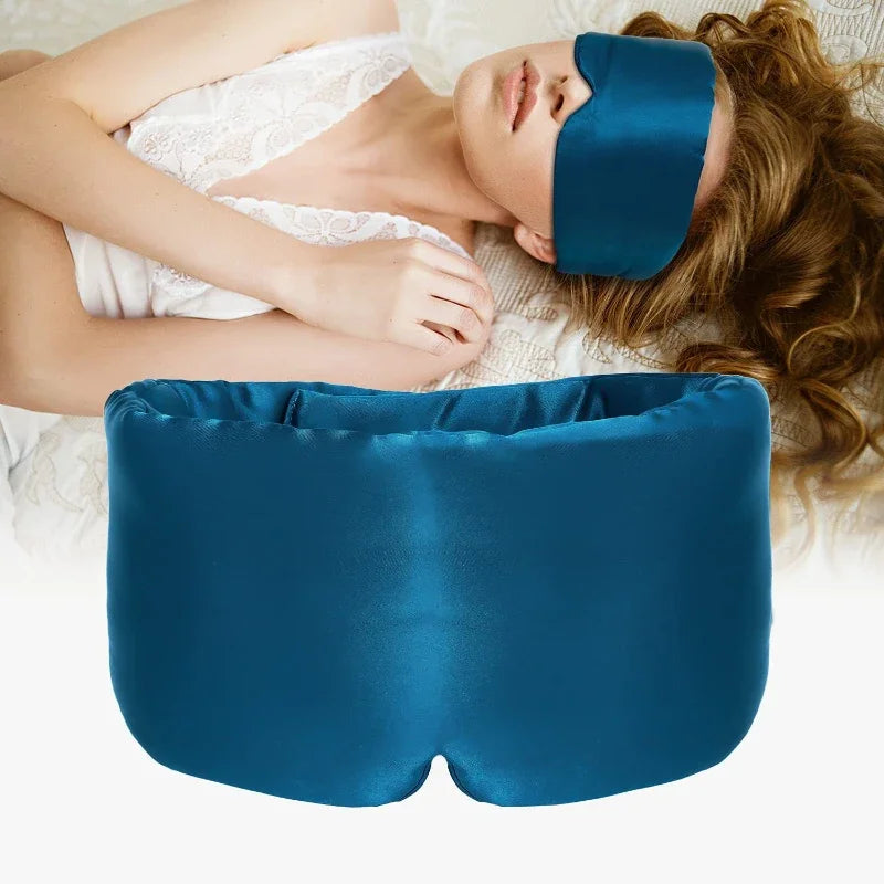 Person wearing a blue eye mask and using a blue pillow on a white  Nº 14 Bleu Céleste background